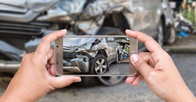 taking a picture of a car wreck after an accident