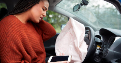 Woman calling a car accident attorney after a crash