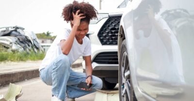 woman stressed out at car crash site